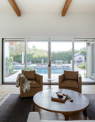 A living room with hardwood floors and a sliding glass door.