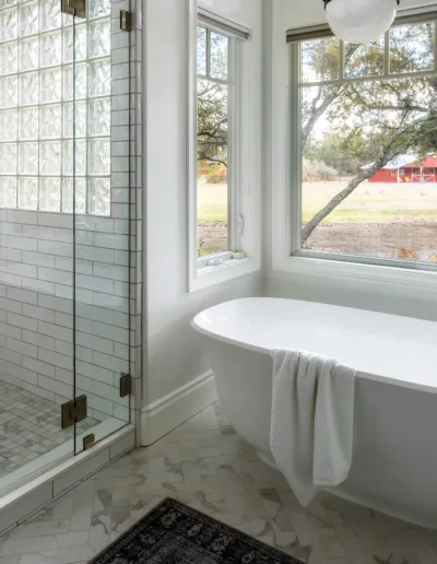 A white bathroom with a glass shower door.