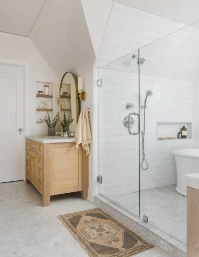 A white bathroom with a glass shower stall.