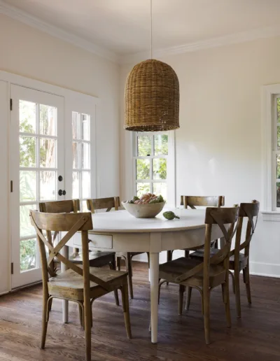 A dining room with a white table and chairs.