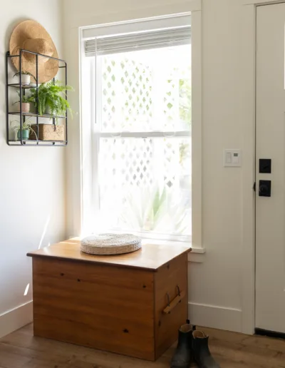 A wooden box sits in front of a window.