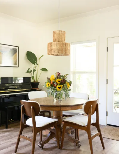 A dining room with a wooden table and chairs.