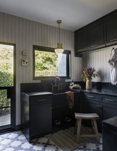 A black and white kitchen with a tile floor.